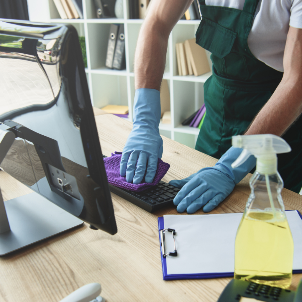 A man cleaning an office desk